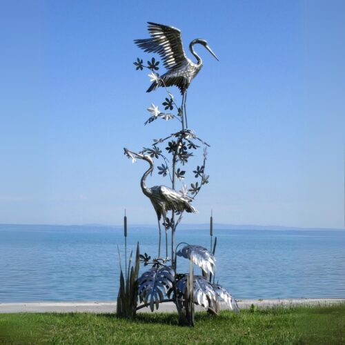 paire de statue hérons cigognes xxl ailes en acier inoxydable sur plantes végétaux 300cm oiseau